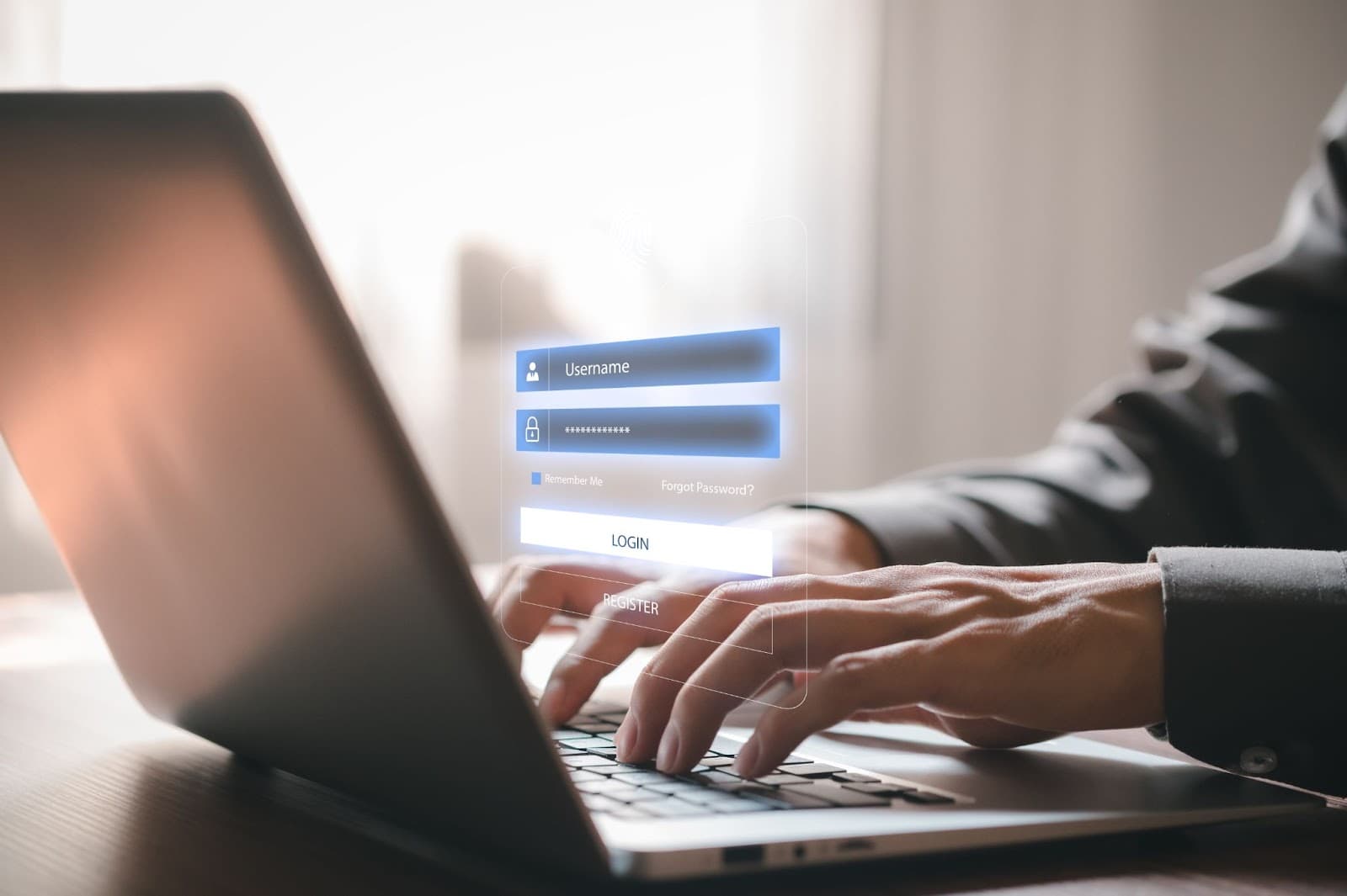 Man typing on a laptop showing a virtual screen