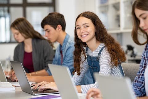 A girl staring at the camera smiling