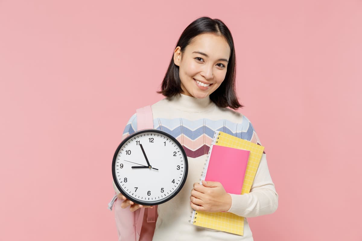 A girl holding a clock