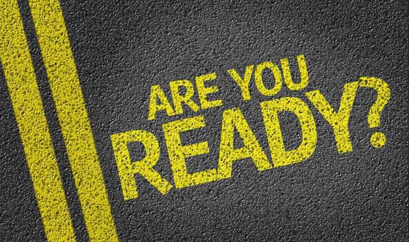 The phrase “ARE YOU READY?” in bold yellow lettering on a textured black surface with yellow lines.